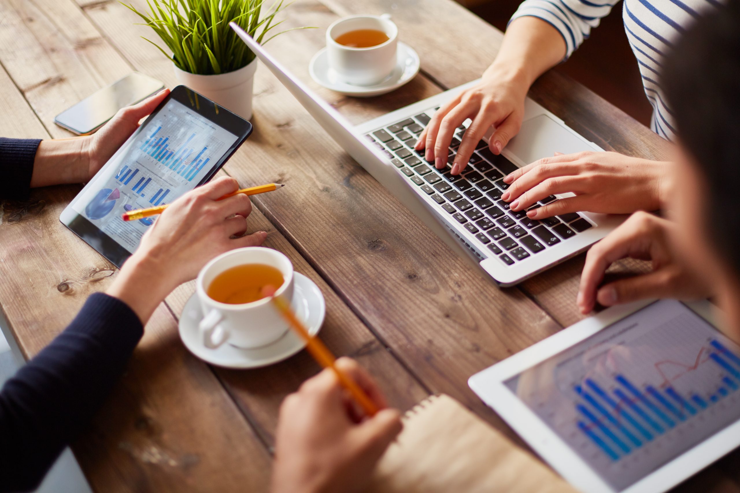 Hands of businesspeople during work with information technologies